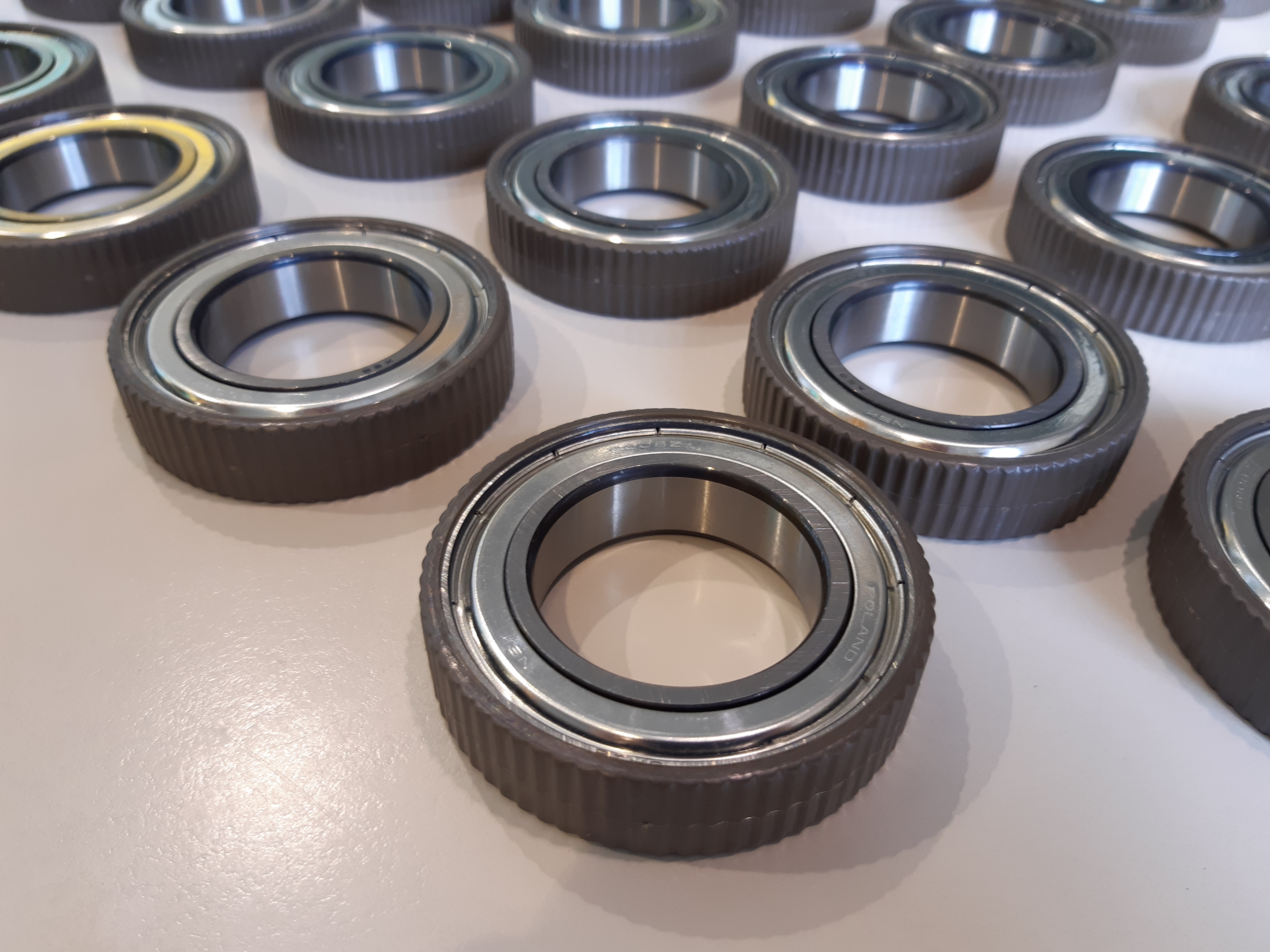Over-moulded deep groove ball bearings